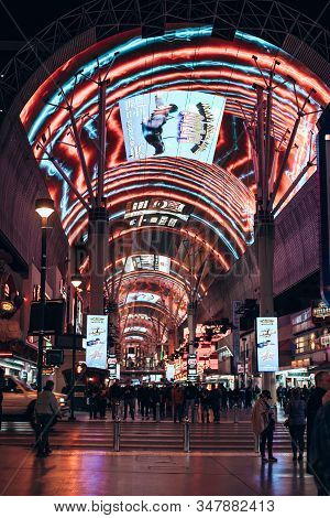 Las Vegas, Usa - December, 2019 Tourists Outside The Pioneer Watch The Freemont Street Experience Li