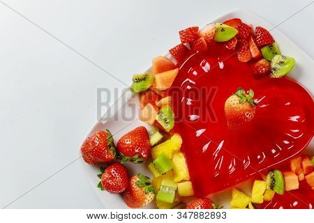 Heart Shape Strawberry Gelatin Decorated With Fresh Strawberry, Kiwi And Pineapple. Dessert For Coup