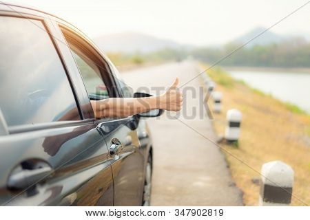 Hand Of Man Traveler With Thumbs Up From Car Form The Asphalt Road Go To Travel With Beautiful Lands