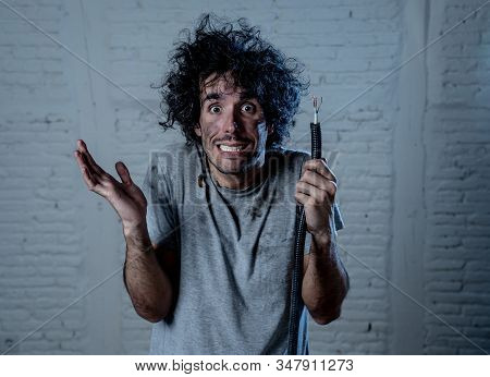 Funny Image Of Man Holding Electrical Cable After Getting Electric Shock