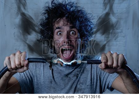 Man Getting Electric Shock Connecting Broken Electrical Cables At Home. Husband Having Domestic Acci