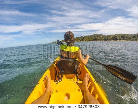 Roatan, Honduras »; January 1, 2020: A Young Woman In A Yellow Canoe In Sandy Bay In Roatan