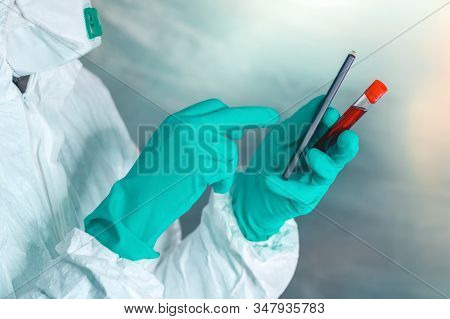 Epidemiologist With Smartphone And Blood Sample In Test Tube, Selective Focus
