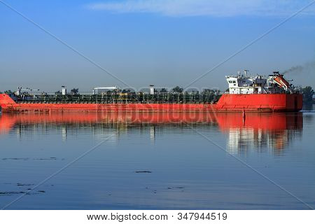 Large Metal Transport Ship Bulk Carrier. A Barge Sailing With A Cargo Of Containers From The Port Al
