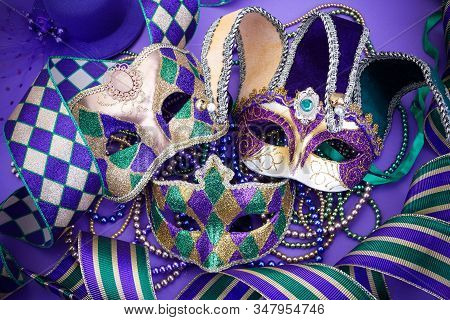 Festive Mardi Gras, Venetian Or Carnivale Mask On A Purple Background. Top View