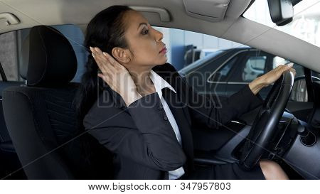 Businesswoman In Car Looking In Rear-view Mirror, Overconfidence, Narcissism