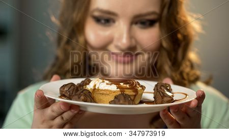 Fat Lady Looking With Admiration At Plate With Sweets And Candies Food Addiction