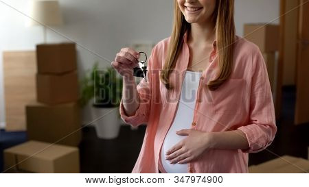Pregnant Woman Holding Key From New Apartment, Affordable Bank Lending, Mortgage