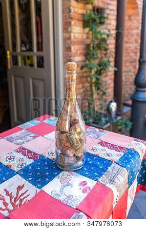 Tbilisi, Georgia, October 14, 2019 : A Bottle Of Wine Filled With Cork Is On The Table On Ioane Shav