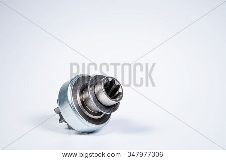 New Spare Parts - Starter Gear Drive For Motor Starter On A Gray Background. Classic Gear Transmissi