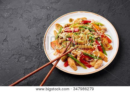 Chicken Chop Suey In White Plate At Black Slate Background. Chop Suey Is American Chinese Cuisine Di