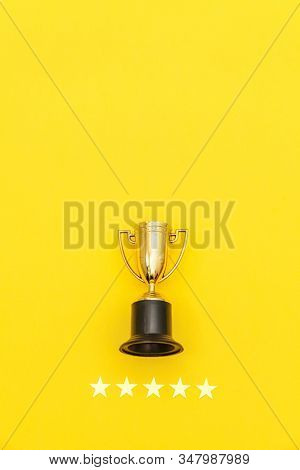 Simply Flat Lay Design Winner Or Champion Gold Trophy Cup And 5 Stars Rating Isolated On Yellow Back