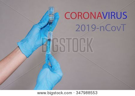A Nurse In A Respiratory Mask And Gloves, Recruits A Vaccine Against Coronavirus In China From Ampul