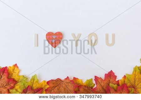 Love Day Concept. The Wooden Text Remain To Valentine's Day With Maple Leaf And White Background.val