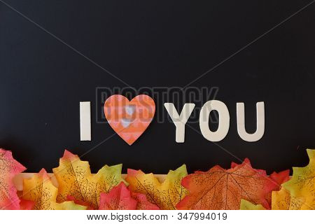 Love Day Concept. The Wooden Text Remain To Valentine's Day With Maple Leaf And Black Background.val