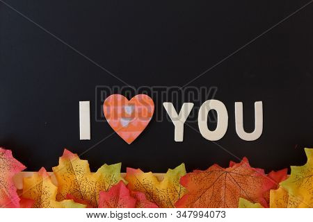 Love Day Concept. The Wooden Text Remain To Valentine's Day With Maple Leaf And Black Background.val