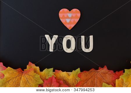 Love Day Concept. The Wooden Text Remain To Valentine's Day With Maple Leaf And Black Background.val