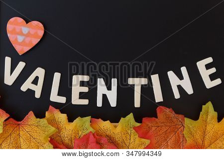 Love Day Concept. The Wooden Text Remain To Valentine's Day With Maple Leaf And Black Background.val