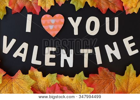 Love Day Concept. The Wooden Text Remain To Valentine's Day With Maple Leaf And Black Background.val