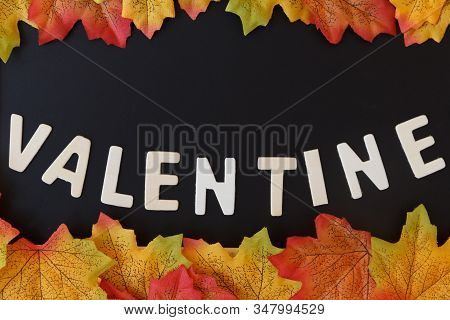 Love Day Concept. The Wooden Text Remain To Valentine's Day With Maple Leaf And Black Background.val