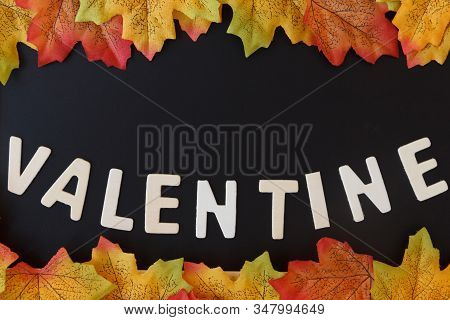 Love Day Concept. The Wooden Text Remain To Valentine's Day With Maple Leaf And Black Background.val