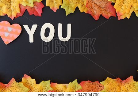 Love Day Concept. The Wooden Text Remain To Valentine's Day With Maple Leaf And Black Background.val