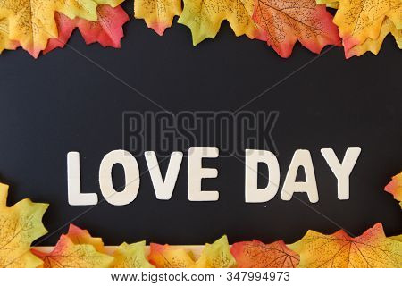 Love Day Concept. The Wooden Text Remain To Valentine's Day With Maple Leaf And Black Background.val