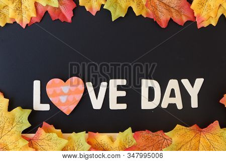 Love Day Concept. The Wooden Text Remain To Valentine's Day With Maple Leaf And Black Background.val