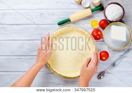 Raw Shortbread Dough For Baking Tart With Tomatoes And Cheeses Filling In Glass Round Baking Form On