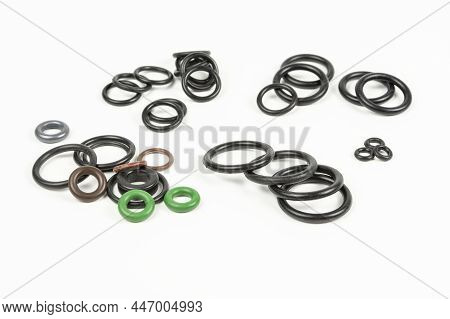 Hydraulic And Pneumatic O-rings In Different Sizes And Colors, On A White Background. Various Seals 