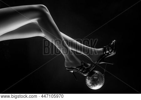 Celebrate Concept. Heels With Gold Ball. Disco And Party Legs. Party Time.