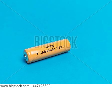 Rechargeable Nicd Aa Size Battery Isolated On Blue Background.