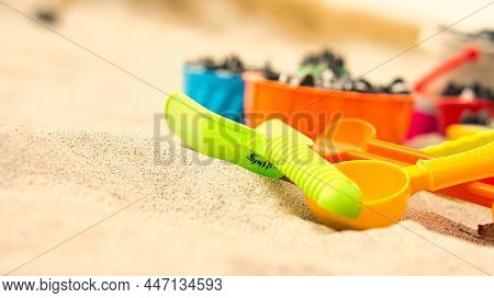Colorful Toys On The Beach For Children To Dig. Sand Is Used To Build Castles And Shapes. Beach Vaca