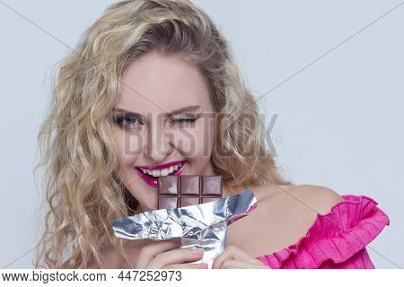 Food Ideas. Closeup Portrait Of Positive Smiling Caucasian Blond Girl With Unwrapped Bar Of Chocolat