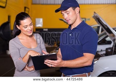 auto mechanic and female customer in garage