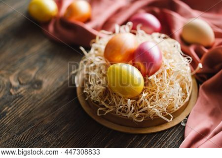 Multicolored Easter Eggs On A Wooden Background. Easter Background. Copy Space. Easter Eggs Flat Lay