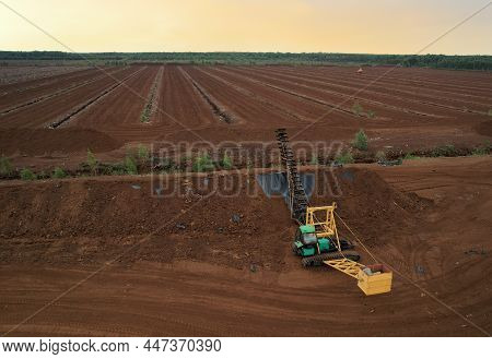 Peat Harvesting Field. Peat Mining Machine At Peatland Harvester On Collecting Extracting Peat. Soft