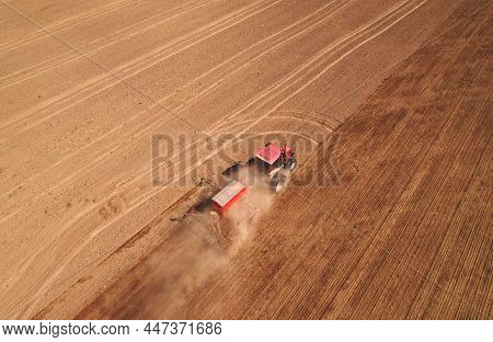 Tractor Sowing Seed Onto At Field. Planting Equipment And Farm Implements And Machine. Mini Agricult