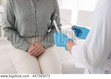 Doctor Taking Sample For Std Testing From Woman In Clinic, Closeup