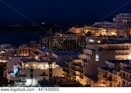 Mellieha, Malta - 01 07 2022: High Angle View By Night Over The Valley Towards The Seaside