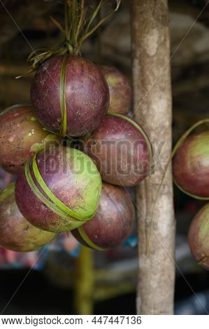 Photo Shows Several Purple Tropical Fruits. One Fruit Is Cut Open And The Inside Of It Is Visible. C