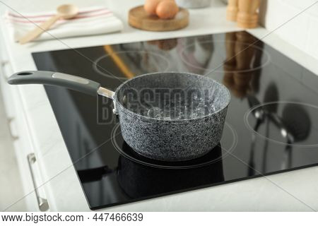 Saucepan With Boiling Water On Electric Stove In Kitchen. Cooking Utensil