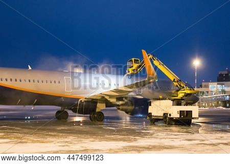 Ground Deicing Of A Passenger Aircraft On The Night Airport Apron
