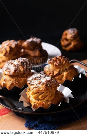 Food Concept Homemade Caramel Choux A La Cream Or Choux Cream Puffs On Dark Background With Copy Spa