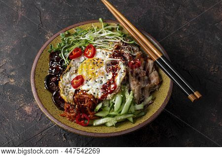 Traditional Korean Dish Bibimbap. Bowl With Rice, Shiitake Mushrooms, Chicken, Cucumber And Microgre