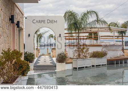 Side, Turkey -january 22, 2022:  Showcase Of Сarpe Diem Restaurant With Many Flowerbeds And Palm Tre