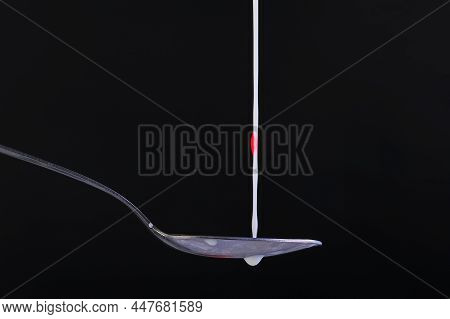 Splash Of Fresh Milk On A Spoon
