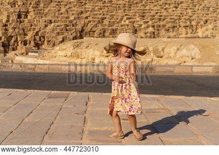 Cute Little Girl Dancing In Front Of The Cheops Pyramid On The Giza Plateau
