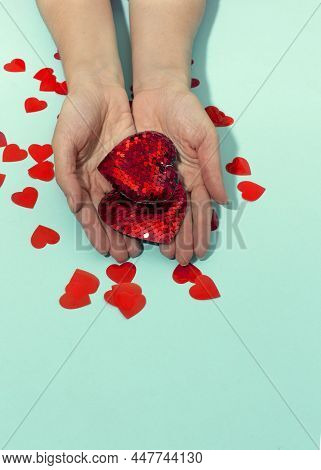 Valentine's Day. Two Haerts In Hands And Confetti On Blue Background. Valentines Day Background. Fla