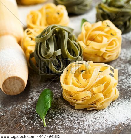 Tagliatelle Paglia E Fieno. On A Dark Background. Making Homemade Pasta Linguine On Rustic Kitchen T